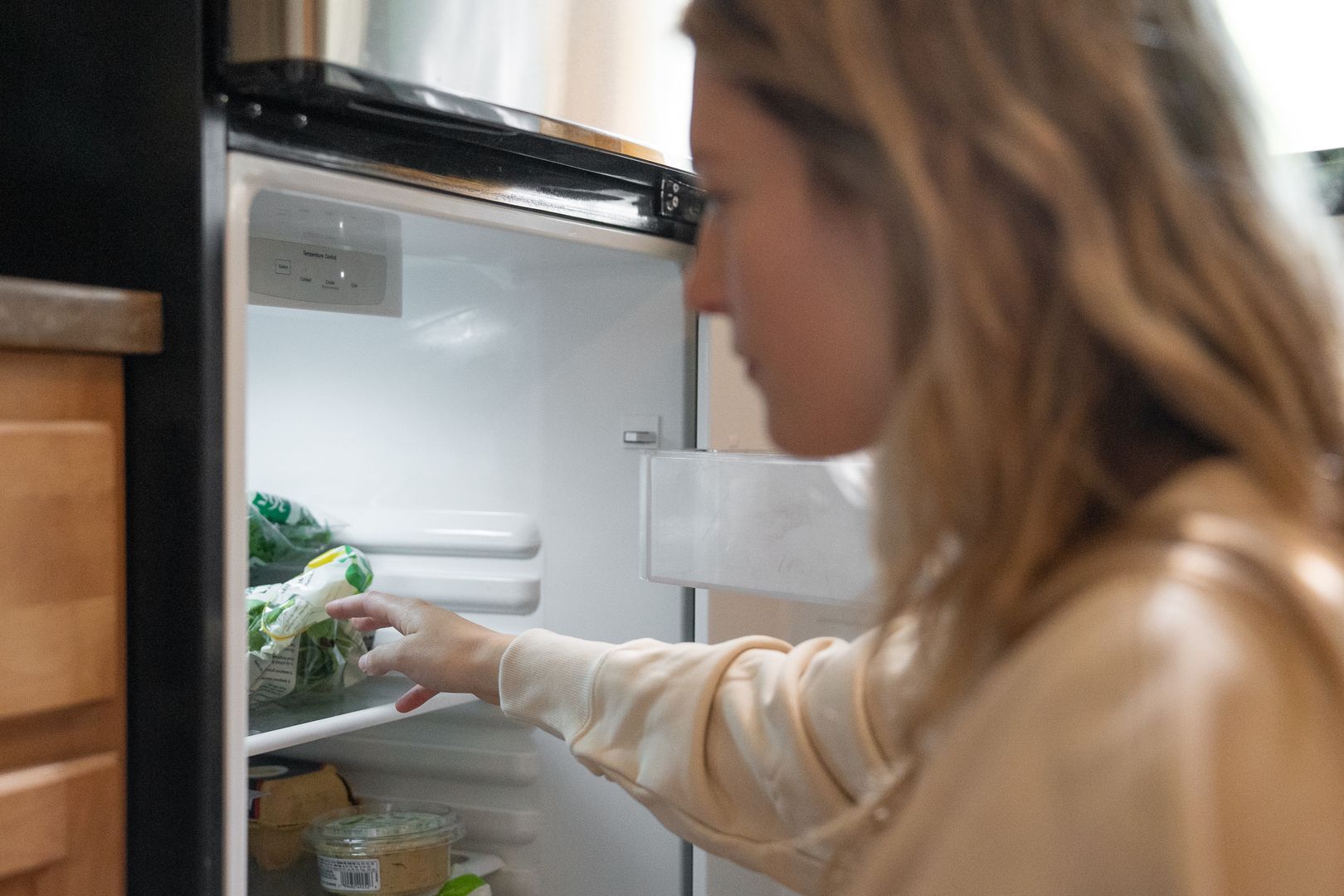 Compact top-freezer refrigerator in apartment kitchen